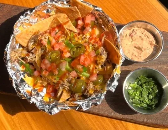 Homemade nachos with pulled pork, chipotle sauce and pico de gallo at Sunday Best Seoul