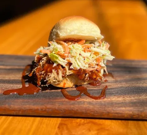 Pulled pork slider on a homemade potato bun with coleslaw at Sunday Best Seoul